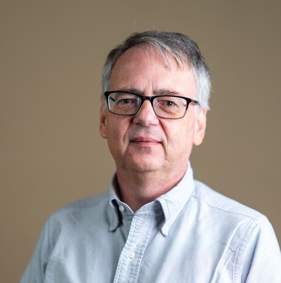 Photo of Andrew Reid, a middle-aged white man with a white shirt.