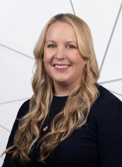 headshot of woman with long blond hair wearing a black top