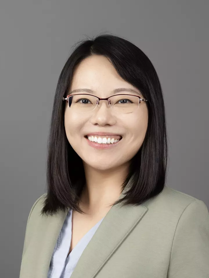 Professional headshot of Ran Tao, a woman with medium length, dark hair and glasses, smiling.