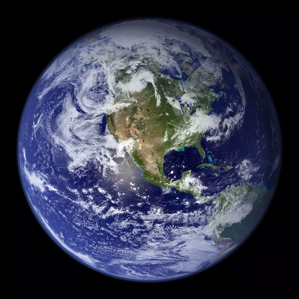 View of Earth from space shows North America and swirling clouds.