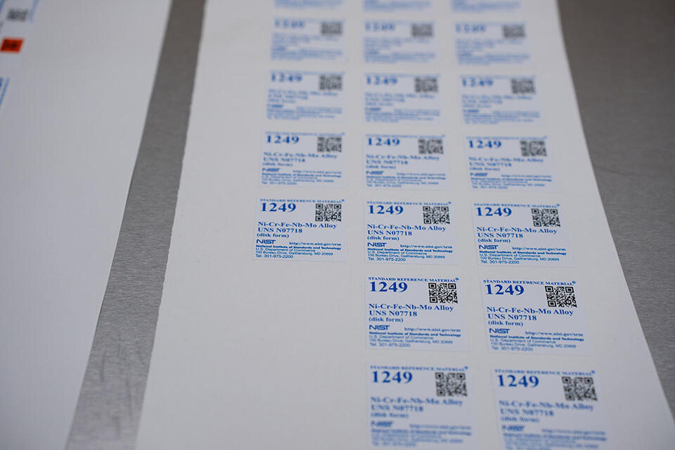 A sheet of square NIST labels saying "Standard Reference Material 1249."