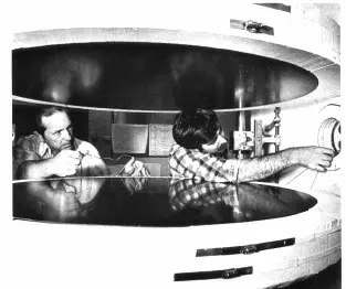 two men working on a 1000-mm guarded hot plate. black & white.