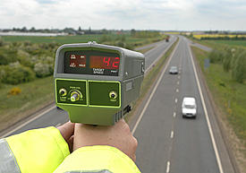 police officer uses radar device