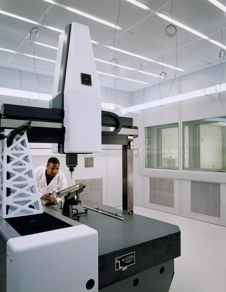 Man standing by a machine