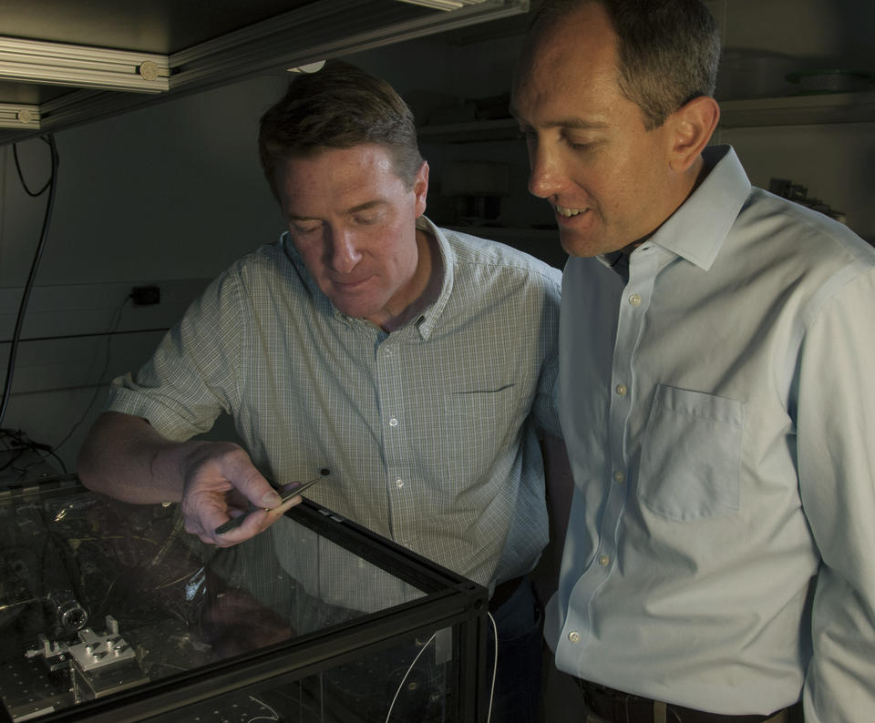 NIST physicists Scott Diddams (left) and Scott Papp