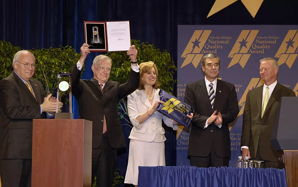 Five people receiving an award