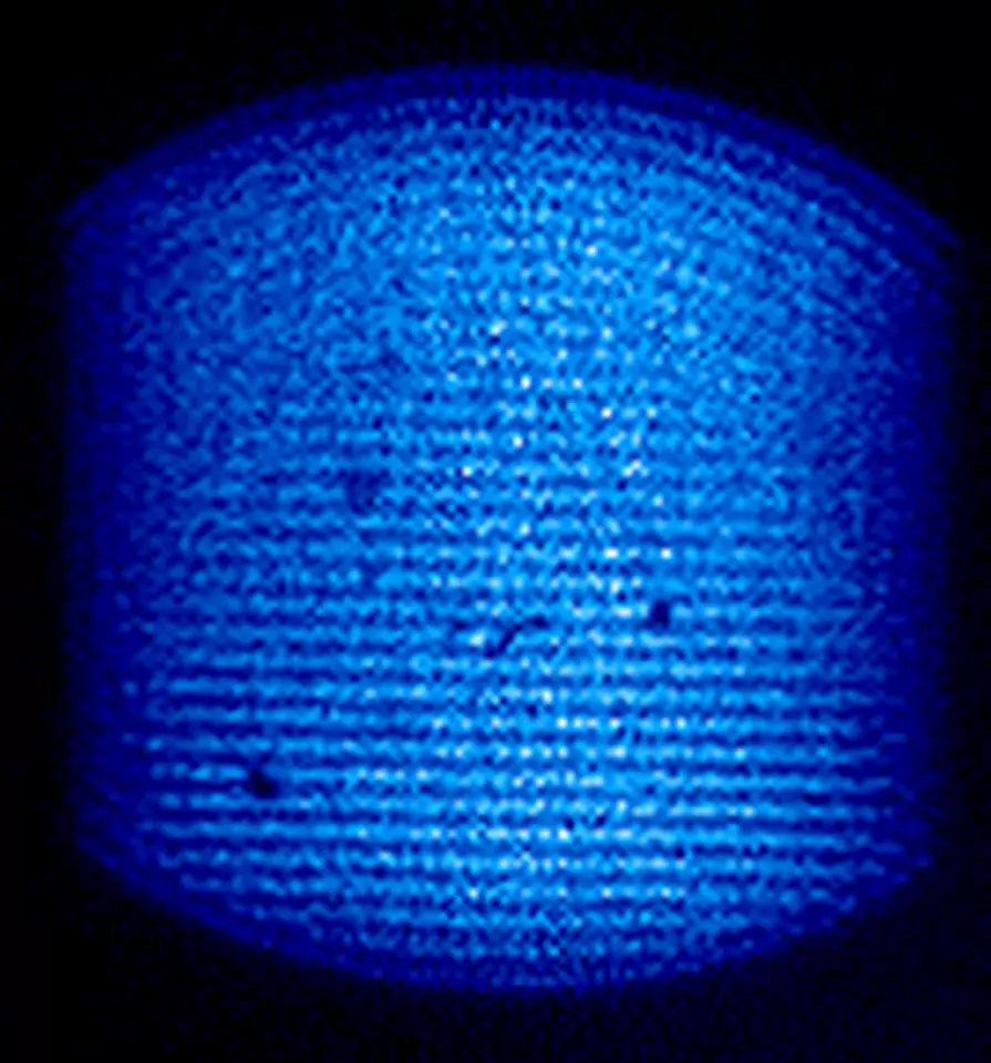 Black background with cylinder of blue dots