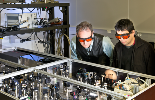 photo of researchers at optics table