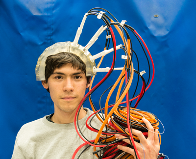 student wearing helmet with multi-colored wires 