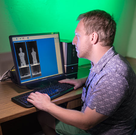 NIST researcher Jack Glover with a scanner image of the phantom