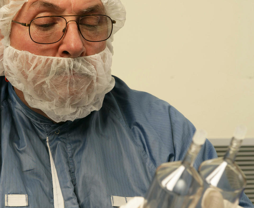 MEDRAD photo of employee holding glass containers in a lab.