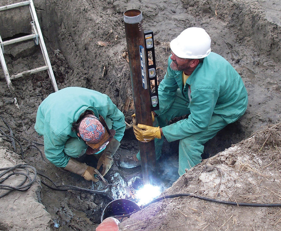 MESA Products, Inc. photo of employees installing a cathodic protection system.