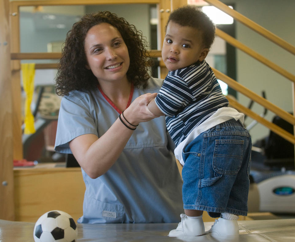 North Mississippi Health Services photo of nurse with toddle patient.