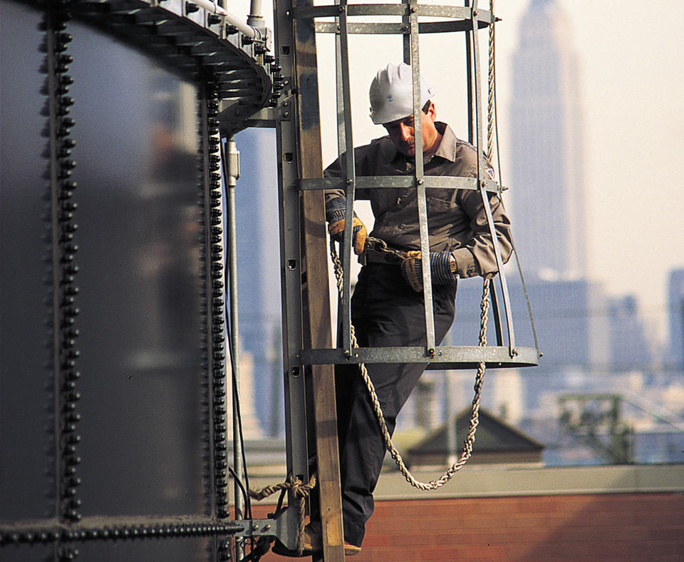 Operations Management International, Inc. photo of man working on the side of a drinking water treatment facility.