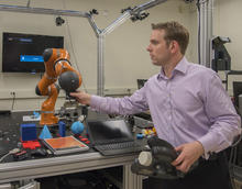 Jeremy Marvel adjusts robotic arm