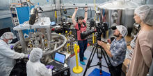 Film crew films a pair NIST researchers operating the NIST Kibble balance