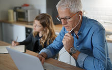 Father working and daughter e-learning form home.