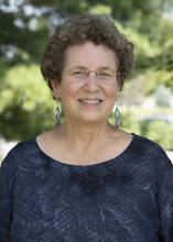 woman with brown hair and glasses