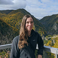 woman standing in front of green mountains