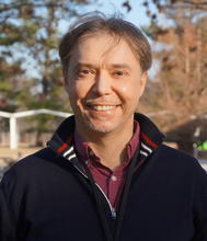 Mauro Zammarano poses outdoors for a head shot. 