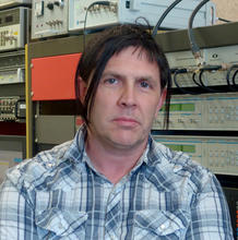 Photo  of person in front of electronic equipment