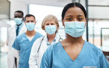 Group of medical professionals standing together in hospital. 