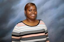 Kandice Taylor poses smiling for a head shot.