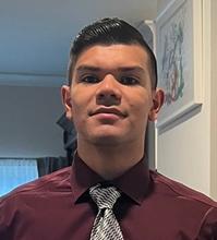 Headshot of a person standing inside a building 