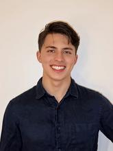 George Sellers poses for a casual head shot against a white wall. 