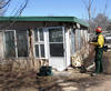 A member of a joint NIST-Texas Forest Service study team collects data on a Amarillo, Texas, building damaged by wildfires in February 2011.