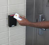 Photo of a person holding a PIV card up to a reader