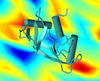 ribbon of protein stands in the foreground against a computer-simulation of a stress field in a glassy material