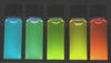 Photo of brightly glowing vials of highly luminescent, water soluble quantum dots