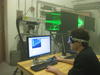 Photo of NIST scientist using Particle Image Velocimetry to measure the air flow distribution through a heat pump component.