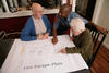 Three people looking at drawing of Fire Escape Plan