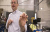 researcher in lab holding brain tissue