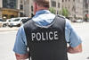 Photo of police officer from behind wearing body armor labeled Police