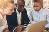 stock image of workers around a computer