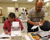 Instructors perform measurements during dry run of Fundamentals of Metrology course