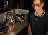NIST engineer Tasshi Dennis with NIST's solar simulator based on a white light laser.