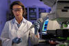 NIST biomedical engineer Laurie Locascio places a water sample on a highly sensitive, inexpensive "lab-on-a-chip"