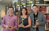 three people hold Emmy Awards in the NIST library