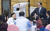 A group of people around a table talking to each other during a training session.