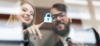 Employees pressing a lock icon representing cybersecurity