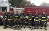 PSCR firefighters for a day post for a photo in full gear in front of a fire truck