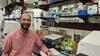 Justin Zook in a lab surrounded by genetic sequencing machines