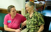 Kindred Nursing and Rehabilitation – Mountain Valley (now Mountain Valley of Cascadia) QE Speaker blog photo of an employee helping an elderly woman.