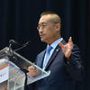 Sokwook Rhee speaking at a podium