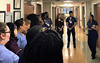 Hospital staff in a tiered huddle to discuss target-zero goals.