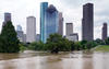 The consequences of Hurricane Harvey showing a flooded park with downtown Houston in the background.